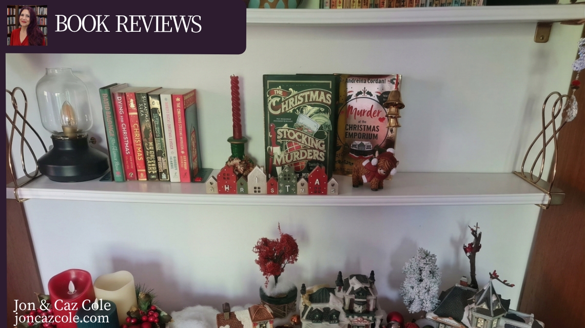 A festive book shelf featuring 'The Christmas Stocking Murders' by Denzil Meyrick alongside Christmas village decorations and candles, styled for the Jon & Caz Cole book review folio.
